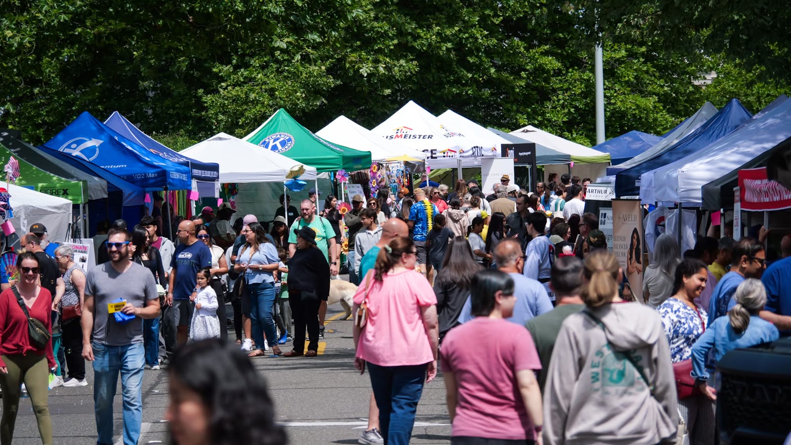Crowds walking between vendor tents at the 2026 Mill Creek Festival